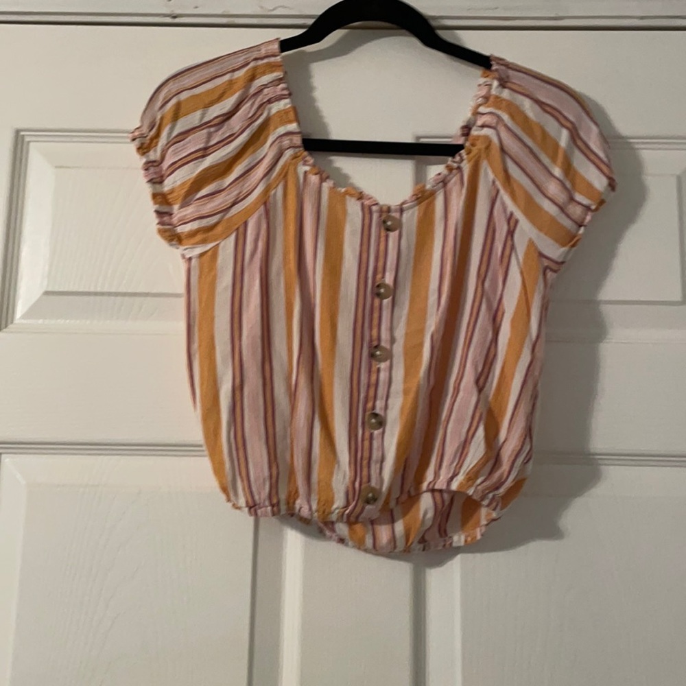Striped blouse with tan buttons.